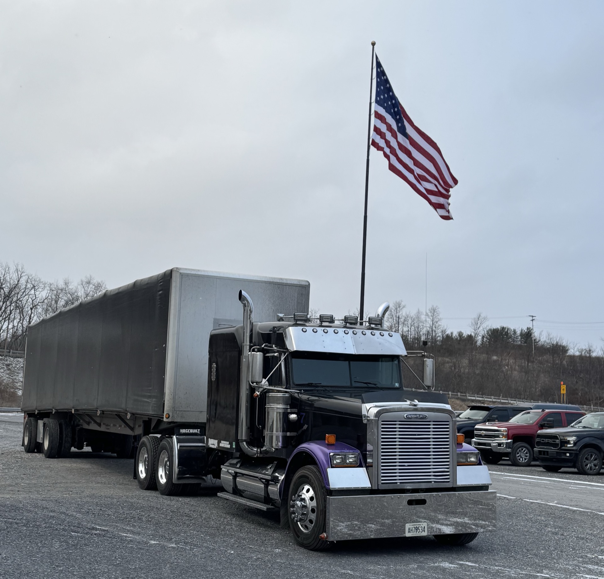 Black Freightliner under American flag
